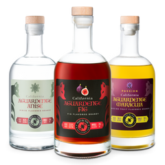 Three bottles of California Aguardente with different flavors on a white background