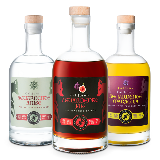 Three bottles of California Aguardente with different flavors on a white background