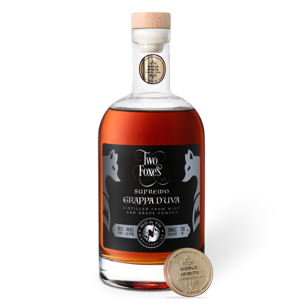 Bottle of Two Foxes Grappa d'uva with a San Francisco World Spirits Competition gold medal on a white background